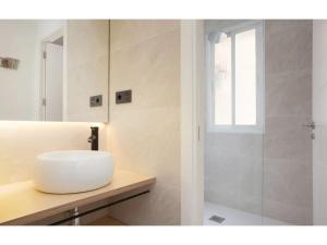 a bathroom with a sink and a shower at Retiro Park Apartments in Madrid