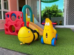 a childs play area with toys on the grass at 歐拉民宿 l 大空間包棟 l 親子溜滑梯 l 專業音響 in Taitung City