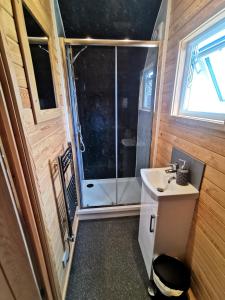 a bathroom with a sink and a shower at Glamping Pods Nr Port Isaac in Port Isaac