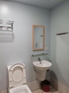 a white bathroom with a toilet and a sink at HORIZON 101 A4 near robinson mall Free POOL WIFI in Cebu City