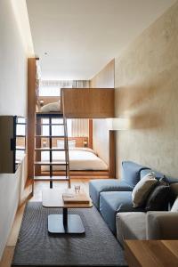 a living room with a couch and a bunk bed at MUJI HOTEL GINZA in Tokyo