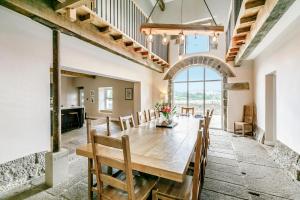 a dining room with a wooden table and chairs at Top Barn in Sowerby Bridge