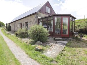 a small house with glass doors on the side of it at Blairgorm Croft in Nethy Bridge