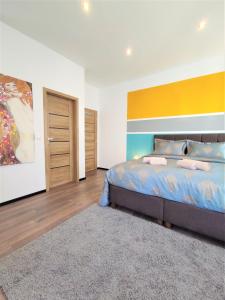 a bedroom with a bed with a colorful wall at Studio Hadersdorf near Train station with Free Parking in Hadersdorf am Kamp +17 photos
