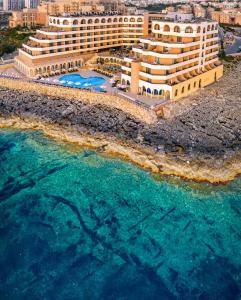 a beach scene with a large body of water at Radisson Blu Resort, Malta St. Julian's in St Julian's