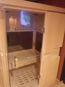 a bathroom with a tv in a room at chambre avec spa privatif in Loon-Plage