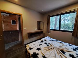 a bedroom with a bed and a large window at Vista Cottage 2 in Ulcinj