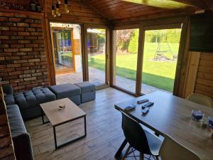 a living room with a table and a couch at OSTOJA in Karpicko
