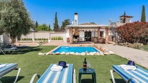 a backyard with a swimming pool and a house at Capricho de Luna Atarfe by Ruralidays in Atarfe