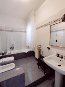 a white bathroom with a sink and a tub at Villa Talìa in Marsala +32 photos