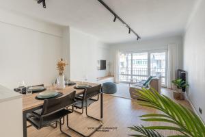 a dining room with a table and chairs in a living room at Luxurious apartment next to the sea and city centre with free parking space in Ostend