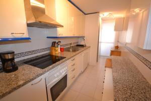A kitchen or kitchenette at marina real 221