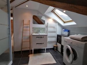 a laundry room with a washer and dryer at LE PANORAMA in Voiron