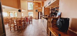 a restaurant with a bar and tables and chairs at Casa de Marinero Villa in Fish Fish