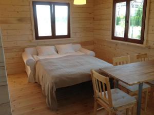 A bed or beds in a room at Domek Morski 2C