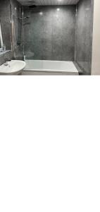 a bathroom with a sink and a bath tub at Lovely one bedroom Apartment in Glasgow City in Glasgow