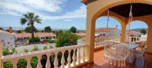 a balcony of a house with a table and chairs at Casa MALIBU in Son Bou