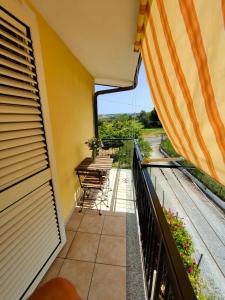 a balcony with tables and chairs and a view at Gullo Capo Vaticano in Ricadi