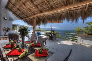 a dining table on a patio with a view of the ocean at Villa Azul in Puerto Vallarta