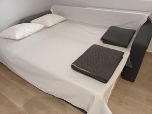 a bed with two mats on top of it at Partcon Apartment A in Neoi Epivates