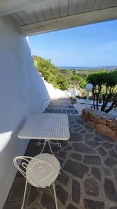 a table and chairs on a patio with a view at casa l'Ulivariu affittacamere in San Teodoro