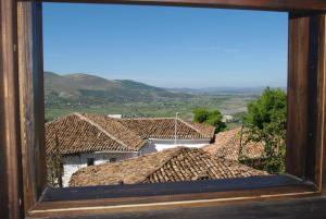a view of roofs of houses from a window at Hotel Klea in Berat