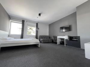 a bedroom with a bed and a chair and a desk at Bell's Hotel in Konstantynów Łódzki +19 photos