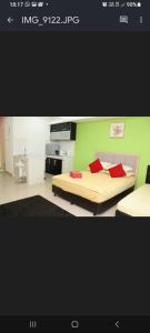 um quarto com uma cama e uma parede verde em The Viana Apartment 2 em Kota Bharu