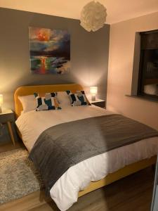 a bedroom with a large bed with two pillows at Natures Rest Apartment in Doolin