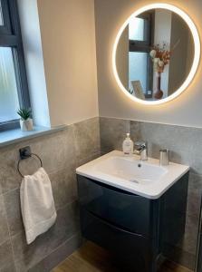a bathroom with a sink and a mirror at Natures Rest Apartment in Doolin