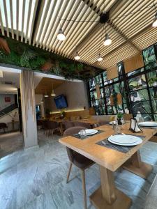 a dining room with a wooden table and chairs at Suite Loc Luxury Aparthotel in Casablanca