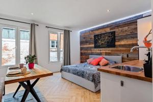 a bedroom with a bed and a kitchen with a sink at Suite city center in quiet street & airco in Antwerp