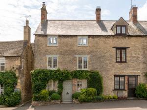 a large brick house with ivy on it at Stow House in Stow on the Wold