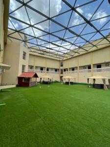 a large building with a large green courtyard with a glass ceiling at Green View Hotel in Abha