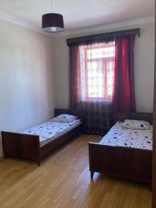 two beds sitting in a room with a window at Gyumri house in Gyumri