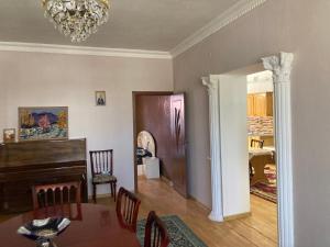 a dining room with a table and a chandelier at Gyumri house in Gyumri