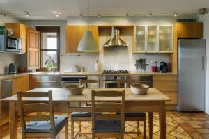 a kitchen with a table and chairs and a refrigerator at Casa Sarasa in Berdún
