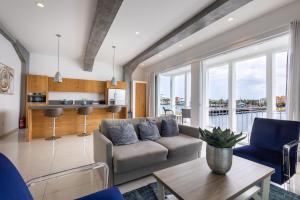 a living room with a couch and a table at Blue Marlin Handelskade Apartments in Willemstad