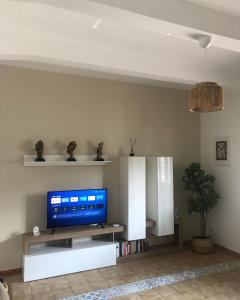 a living room with a flat screen tv on a white entertainment center at Home Ciccilla in Reggio di Calabria