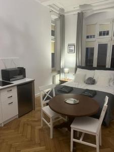 a bedroom with a bed and a table and chairs at Apartamenty u Ewy - EUROS in Ustka