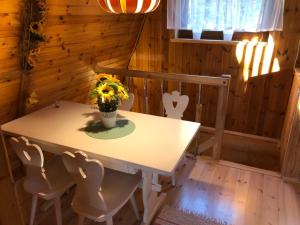 a dining room with a table and chairs at Domek w zaciszu in Grzybowo