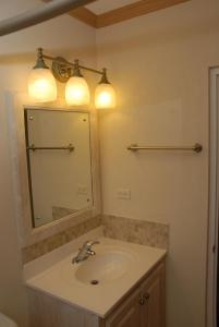 a bathroom with a sink and a mirror at Sandy Bliss Condominiums in Saint James