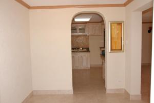 a kitchen with white walls and an archway at Sandy Bliss Condominiums in Saint James