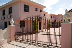 a gate in front of a house at Sandy Bliss Condominiums in Saint James