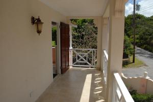 an external view of a house with an open door at Sandy Bliss Condominiums in Saint James