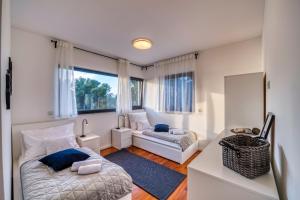 a small bedroom with a bed and a window at Crystal Holiday Residence in Sukošan +93 photos