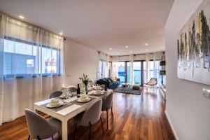 a dining room and living room with a table and chairs at Crystal Holiday Residence in Sukošan