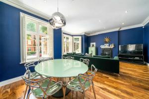 a dining room with a glass table and chairs at NEW Elegant 2BD Flat Maida Vale Central London in London