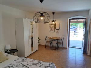 a room with a bed and a table and chairs at Apartments Dandić in Orlec