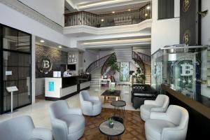 a lobby with chairs and a bar in a building at New Balturk Hotel Izmit in Kocaeli